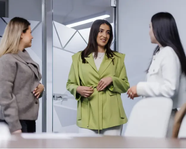 Colleagues having a discussion in an office workspace