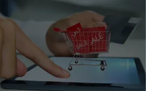 Man playing tablet with shopping cart
