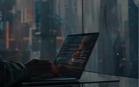 Person coding on a laptop with a futuristic city view