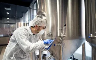 Professional technologist checking production factory